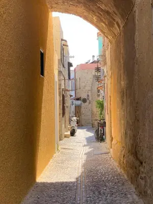 an alley with an archway in an old building at Old Town Retreat in Rhodes Town