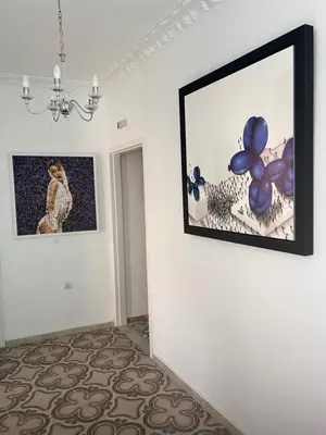 a room with a picture on a wall with blue balloons at Old Town Retreat in Rhodes Town