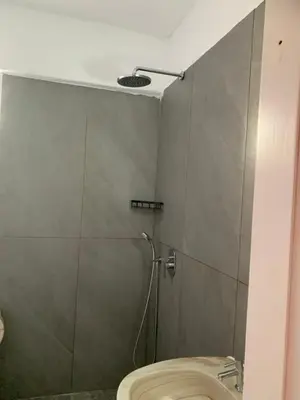 a bathroom with a shower stall with a toilet at Old Town Retreat in Rhodes Town