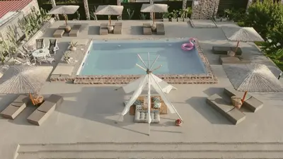 a model of a windmill and a pool with umbrellas at LA Casa Di Lusso Casa N8 Adults Only in Kolimbia