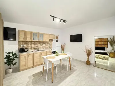 a kitchen with a table and chairs in a room at LA Casa Di Lusso Casa N8 Adults Only in Kolimbia