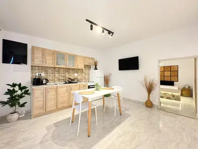 a kitchen with a table and chairs in a room at LA Casa Di Lusso Casa N8 Adults Only in Kolimbia