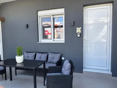 a living room with a couch and a table and a window at Harriet Beauty Studios in Haraki