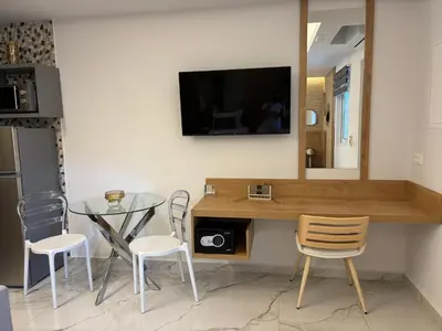 a dining room with a table and chairs and a mirror at Harriet Beauty Studios in Haraki