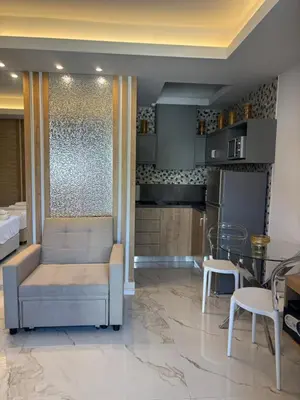 a kitchen with a couch and a table with chairs at Harriet Beauty Studios in Haraki