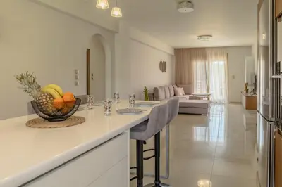 a kitchen with a counter with a bowl of fruit on it at Castle View Archangelos in Archangelos