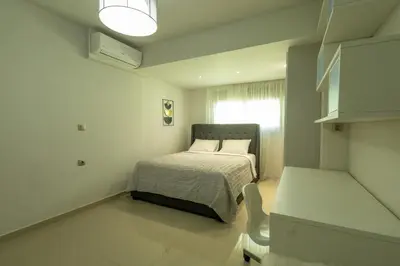 a small bedroom with a bed and a window at Castle View Archangelos in Archangelos