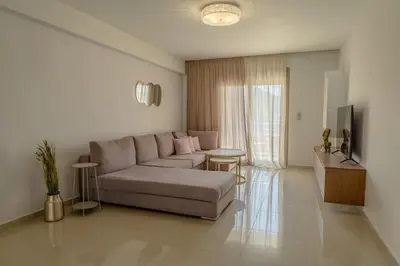 a living room with a couch and a table at Castle View Archangelos in Archangelos