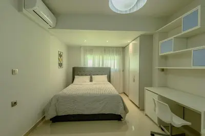 a bedroom with a bed in a white room at Castle View Archangelos in Archangelos