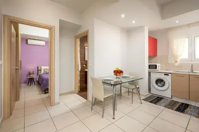 a kitchen and dining room with a table at Levanta Cozy Apartments in Kalavarda Rhodes in Rhodes Town