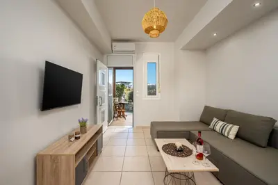 a living room with a couch and a table at Levanta Cozy Apartments in Kalavarda Rhodes in Rhodes Town