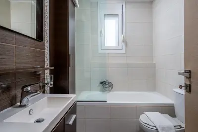 a bathroom with a tub and a toilet and a sink at Levanta Cozy Apartments in Kalavarda Rhodes in Rhodes Town