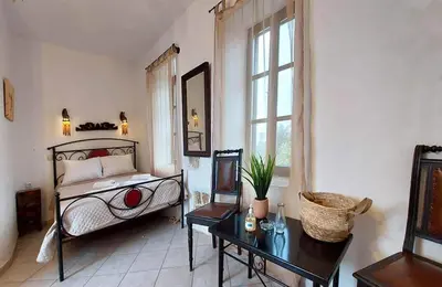 a bedroom with a bed and a table and window at Saint Michel Collection - Old Town in Rhodes Town