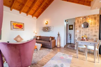 a living room with a couch and a table at Blue Waves House 2 in Soroni