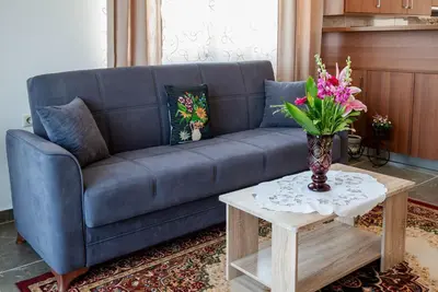 a blue couch sitting in a living room with a table at Serenity Luxury Villa in Paradisi Rhodes in Rhodes Town