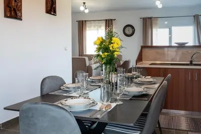 a dining room table with chairs and a table centerpiece at Serenity Luxury Villa in Paradisi Rhodes in Rhodes Town
