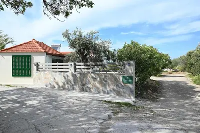 a gate in front of a house with a fence at Myrteni guesthouse in Ialyssos