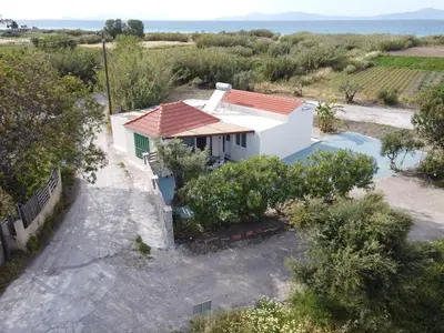 an aerial view of a house with a swimming pool at Myrteni guesthouse in Ialyssos