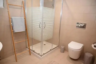 a shower stall in a bathroom with a toilet at Myrteni guesthouse in Ialyssos