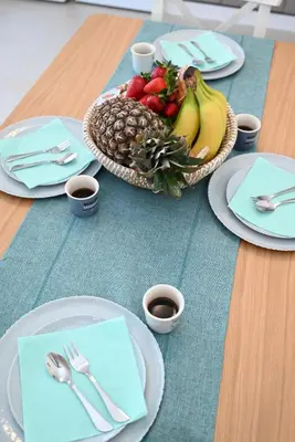 a table with a bowl of fruit and cups of coffee at Myrteni guesthouse in Ialyssos