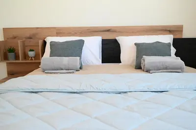 a large bed with two pillows on top of it at Myrteni guesthouse in Ialyssos