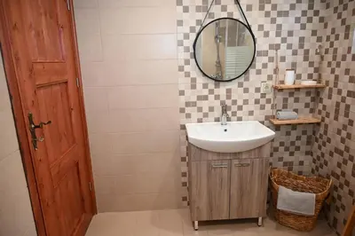 a bathroom with a sink and a mirror at Myrteni guesthouse in Ialyssos