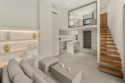 a living room with a couch and a staircase at Luxury in Simplicity , Nature's Touch , Mezzanine in Rhodes Town