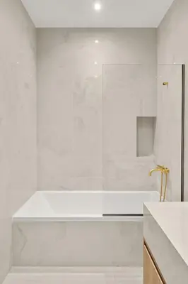 a white bathroom with a tub and a shower at Luxury in Simplicity , Nature's Touch , Mezzanine in Rhodes Town