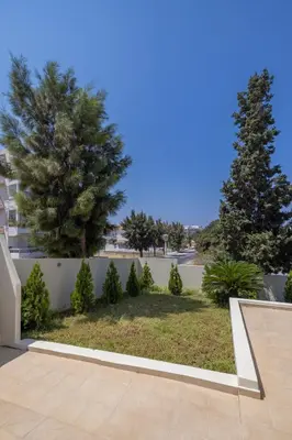 a view of a yard with two pine trees at Luxury in Simplicity , Nature's Touch , Mezzanine in Rhodes Town