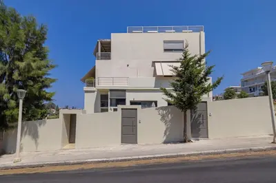 a white building with a tree in front of it at Luxury in Simplicity , Nature's Touch , Mezzanine in Rhodes Town