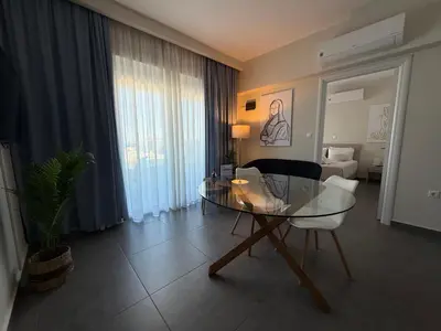 a living room with a glass table and a couch at Arfaras Home in Ixia