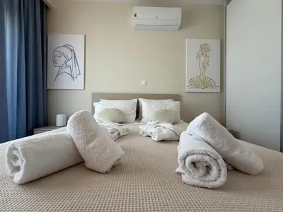 a bedroom with two white towels on a bed at Arfaras Home in Ixia