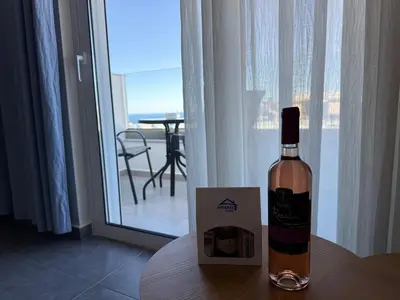 a bottle of wine sitting on top of a table at Arfaras Home in Ixia