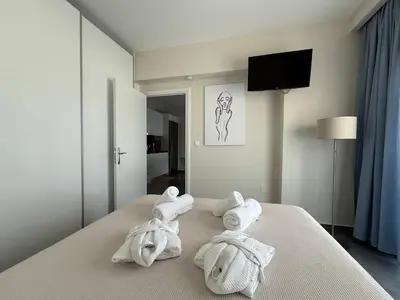 a hotel room with towels on a bed at Arfaras Home in Ixia