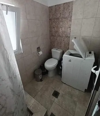 a bathroom with a toilet and a window at La Stella studio in Livadia