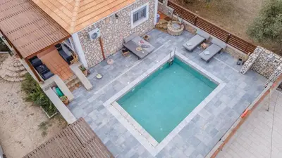 an overhead view of a swimming pool in a backyard at Ampeli Villa in Kolimbia