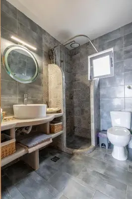 a bathroom with a sink and a toilet at Ampeli Villa in Kolimbia