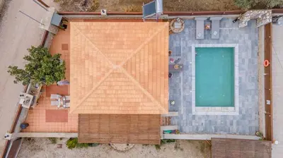 an overhead view of a building with a swimming pool at Ampeli Villa in Kolimbia