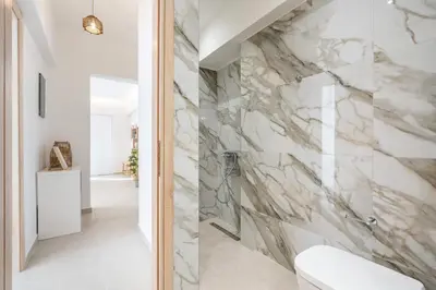 a bathroom with a marble wall at Spiti Apartment Ialysos in Ialyssos