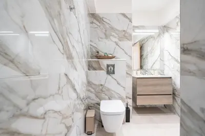 a white bathroom with a toilet and a sink at Spiti Apartment Ialysos in Ialyssos