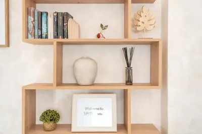 a wooden shelf with a picture and books at Spiti Apartment Ialysos in Ialyssos