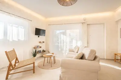 a living room with a couch and a table at Spiti Apartment Ialysos in Ialyssos