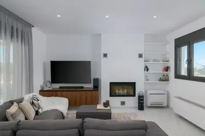 a living room with a couch and a tv at Villa Galini in Haraki
