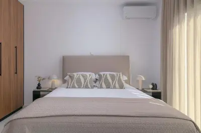 a bedroom with a large bed with two pillows at Villa Galini in Haraki
