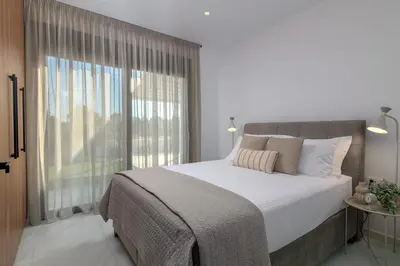 a bedroom with a large bed and a large window at Villa Galini in Haraki