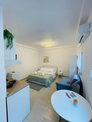 a living room with a bed and a table at Studio 87 in Rhodes Town