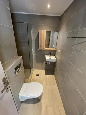 a bathroom with a toilet and a sink at Studio 87 in Rhodes Town