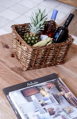 a basket of wine and a magazine on a table at Mea Casa Halki in Halki