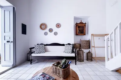 a living room with a couch and a table at Mea Casa Halki in Halki