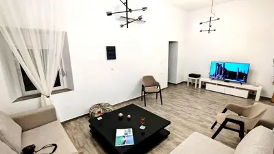 a living room with a couch and a table at Angelica Residence in Gennadi